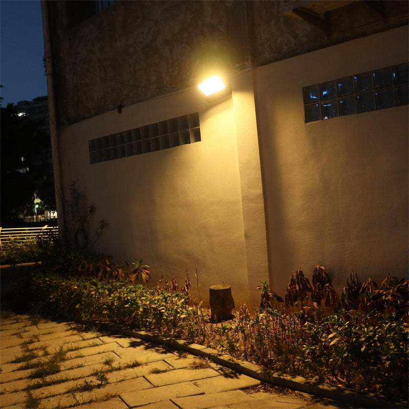 Solaraluma high-output solar flood light in 3000K warm white, perfect for cozy backyard accent lighting and garden ambiance.